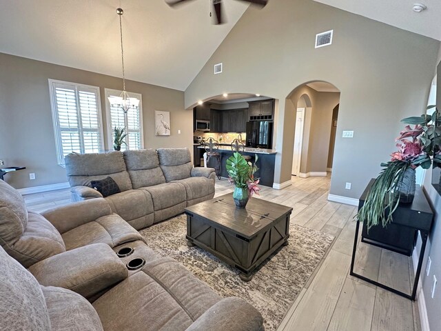 2112 Fm 3186 Unit 9, Onalaska, TX 77360 - living room featuring plenty of natural light, ceiling fan, light wood finished floors, a chandelier, and high vaulted ceiling