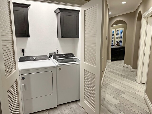 2112 Fm 3186 Unit 9, Onalaska, TX 77360 - washroom featuring cabinet space, washer and dryer, light wood-style floors, baseboards, and recessed lighting