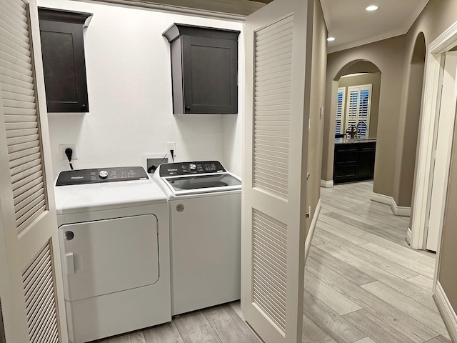 2112 Fm 3186 Unit 9, Onalaska, TX 77360 - laundry area with cabinet space, washing machine and dryer, light wood-style floors, arched walkways, and recessed lighting
