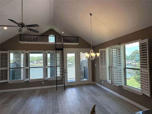 2112 Fm 3186 Unit 9, Onalaska, TX 77360 - unfurnished dining area with vaulted ceiling, a chandelier, ceiling fan, wood finished floors, and healthy amount of natural light