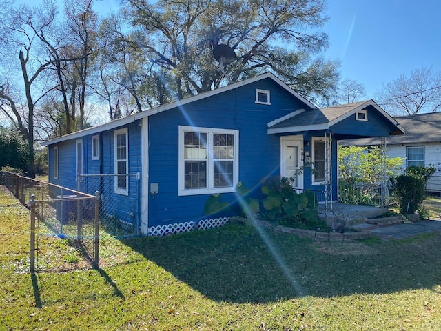 bungalow with a front lawn and fence