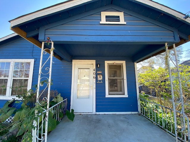 property entrance featuring covered porch