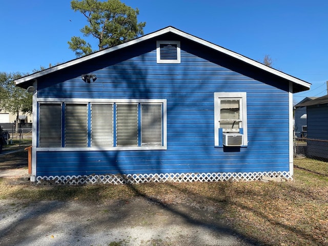 view of side of home with fence and cooling unit
