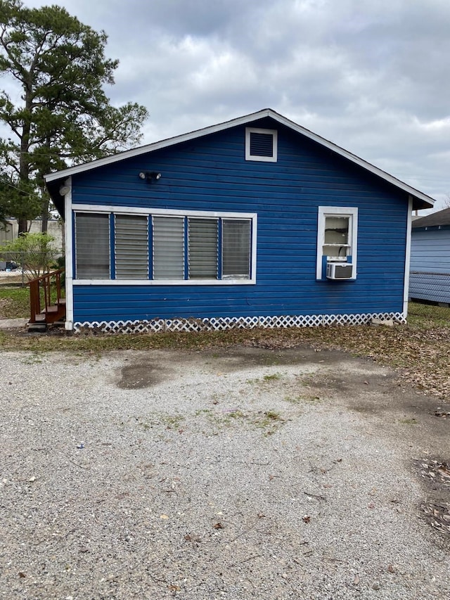 view of side of home featuring cooling unit