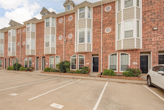 view of property featuring uncovered parking