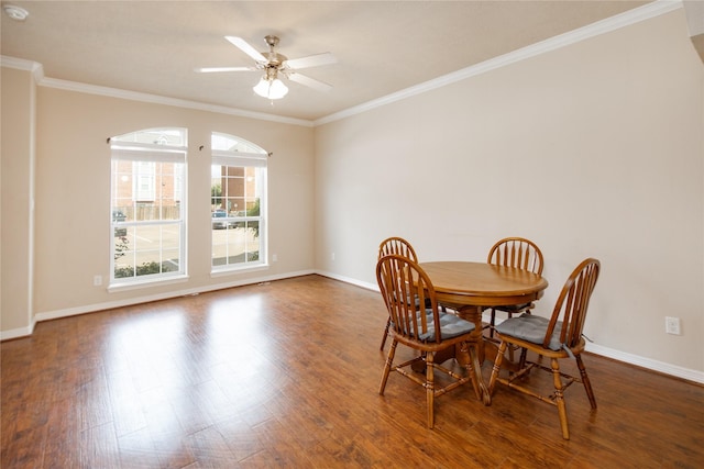 dining space featuring baseboards, ornamental molding, and wood finished floors