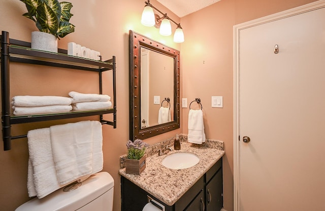 half bathroom featuring toilet and vanity