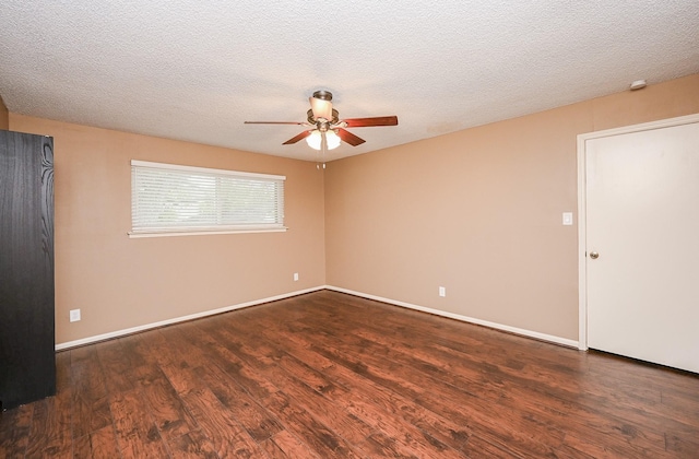 empty room with a ceiling fan, baseboards, and wood finished floors