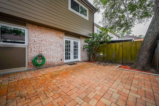 view of patio featuring fence and french doors