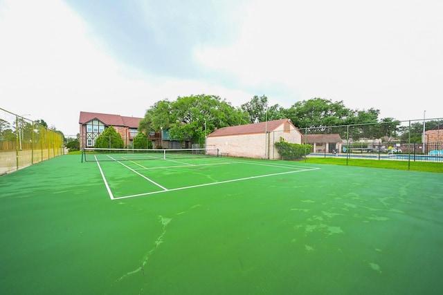 view of sport court with fence