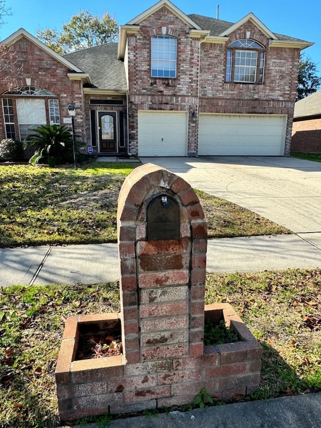 traditional-style house with concrete driveway, brick siding, roof with shingles, and a garage