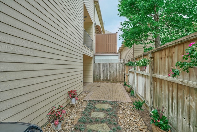 view of side of home featuring fence
