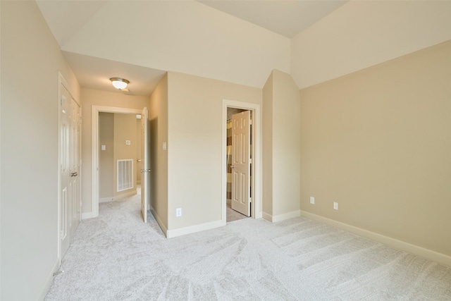 unfurnished bedroom featuring baseboards, light carpet, and visible vents