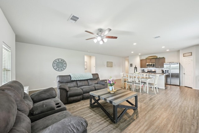 living room with recessed lighting, ceiling fan, light wood finished floors, and visible vents