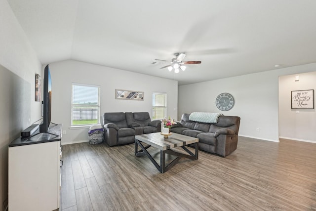 living room featuring baseboards, ceiling fan, wood finished floors, and lofted ceiling