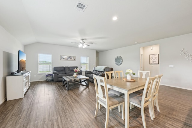 dining room with a ceiling fan, dark wood-style flooring, visible vents, baseboards, and lofted ceiling