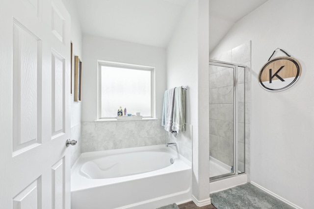 full bathroom with a bath and a stall shower