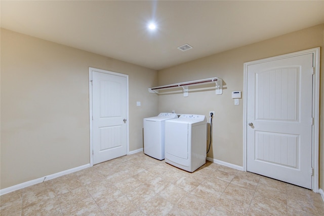 washroom featuring baseboards, laundry area, independent washer and dryer, and visible vents