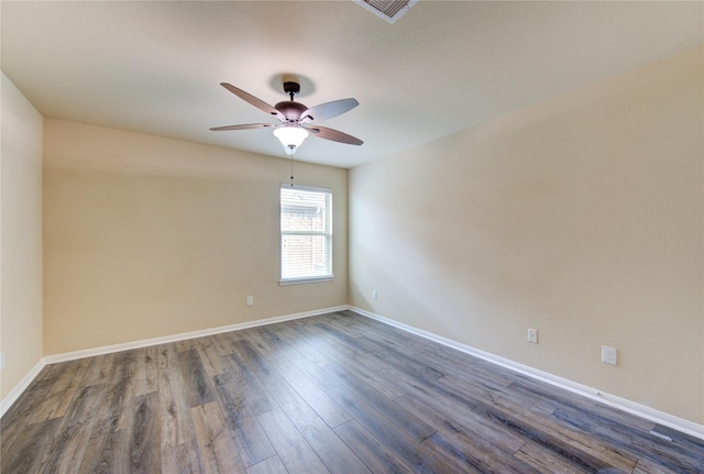 unfurnished room featuring a ceiling fan, baseboards, visible vents, and dark wood-type flooring