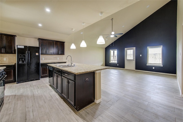 kitchen featuring open floor plan, ceiling fan, high vaulted ceiling, a sink, and black appliances