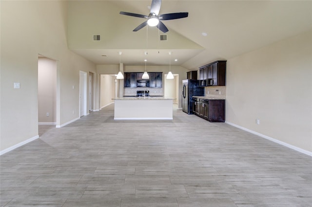 unfurnished living room with baseboards, a ceiling fan, high vaulted ceiling, and visible vents