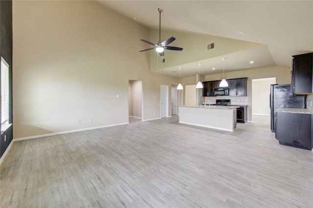 unfurnished living room featuring light wood-style floors, visible vents, ceiling fan, and lofted ceiling