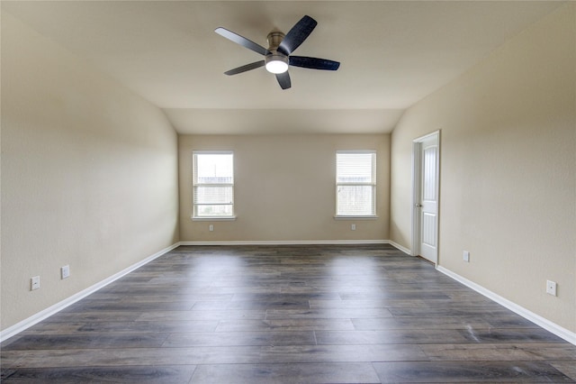 unfurnished room featuring dark wood-type flooring, ceiling fan, lofted ceiling, and a healthy amount of sunlight