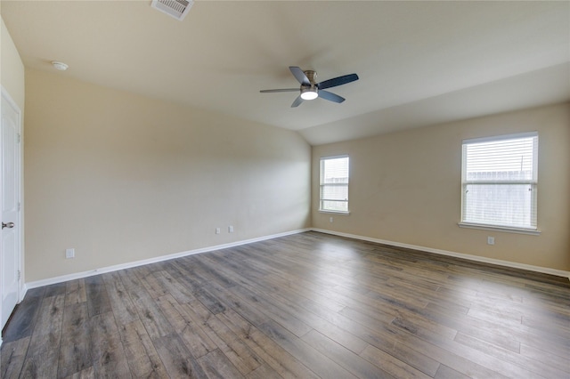 unfurnished room featuring baseboards, ceiling fan, dark wood-style flooring, and visible vents