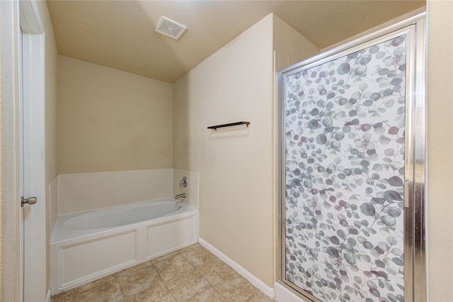 full bath featuring tile patterned flooring, baseboards, a shower stall, visible vents, and a garden tub