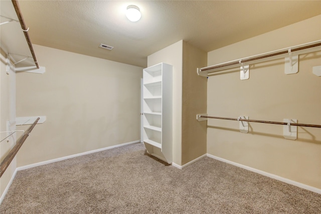 spacious closet featuring visible vents and carpet