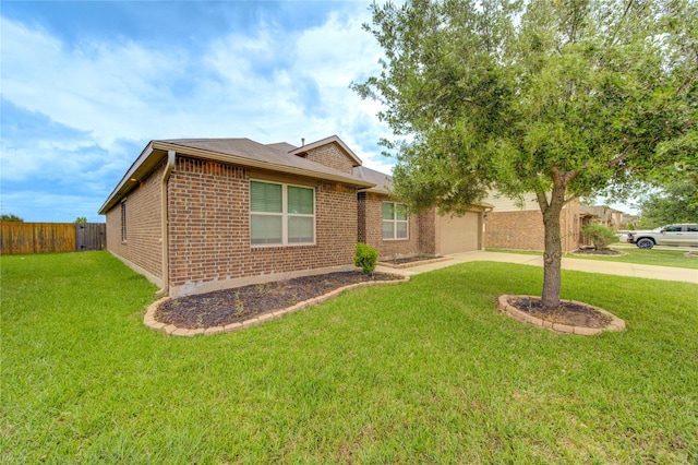 view of front of house with a front lawn, fence, brick siding, an attached garage, and driveway