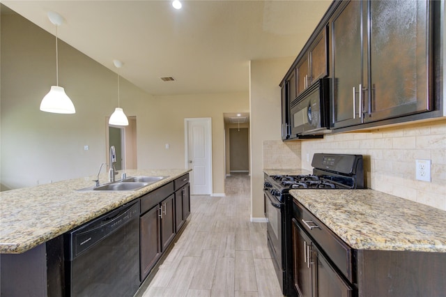 kitchen with baseboards, a sink, black appliances, and dark brown cabinets