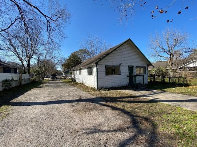 view of home's exterior featuring fence and entry steps