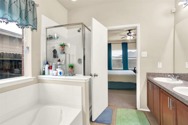 7035 Primrose Rd, Baytown, TX 77521 - ensuite bathroom with a stall shower, a ceiling fan, plenty of natural light, and ensuite bath