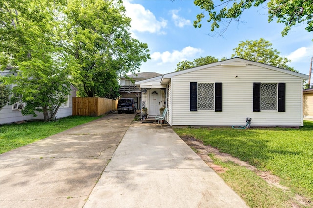 view of front of property with concrete driveway, crawl space, fence, and a front yard