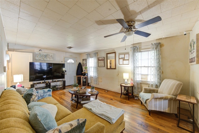 living area with a ceiling fan, hardwood / wood-style flooring, and visible vents
