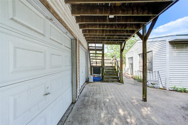 view of patio featuring stairway and a garage