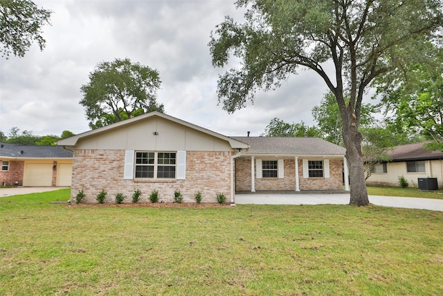 single story home featuring brick siding, a garage, a front yard, central AC unit, and concrete driveway