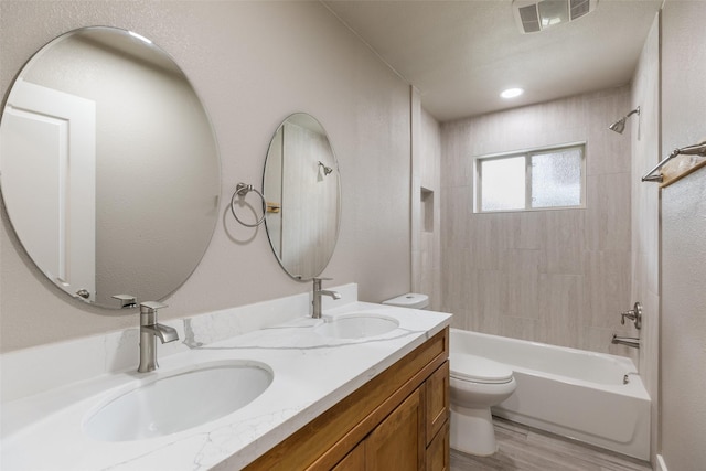 bathroom featuring a sink, bathing tub / shower combination, toilet, and visible vents