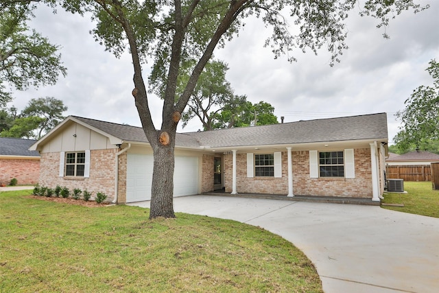 ranch-style house featuring a front yard, central AC, fence, concrete driveway, and an attached garage