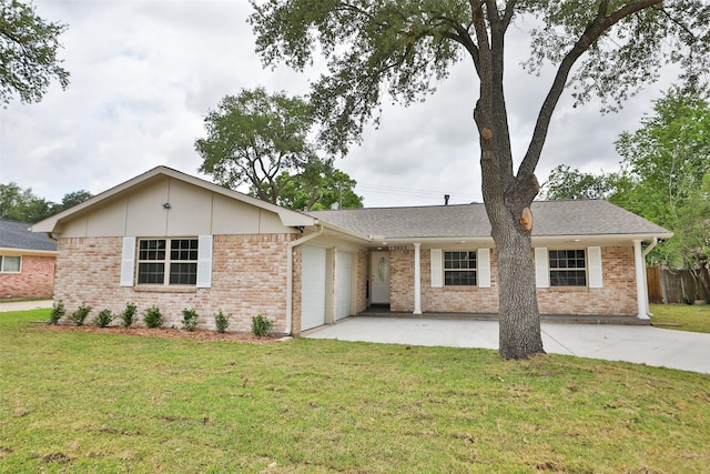 ranch-style home with an attached garage, brick siding, fence, and a front yard