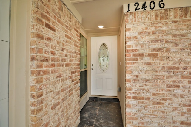 property entrance with brick siding