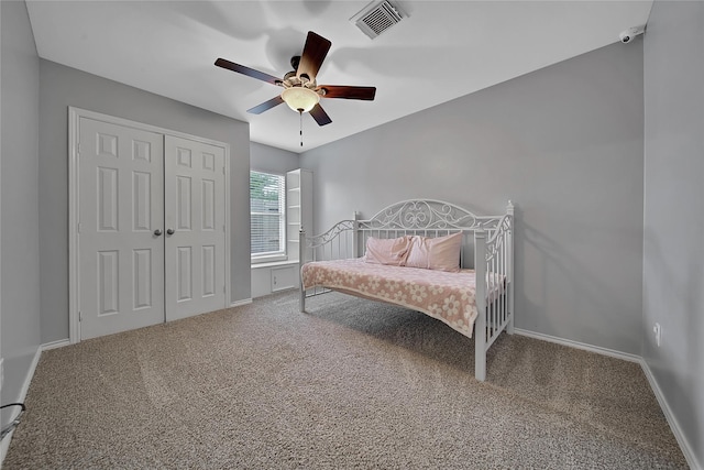 carpeted bedroom featuring visible vents, a ceiling fan, and baseboards
