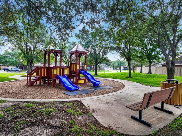 communal playground with fence and a yard