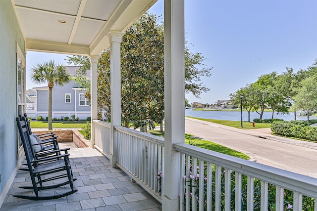 exterior space featuring covered porch and a water view