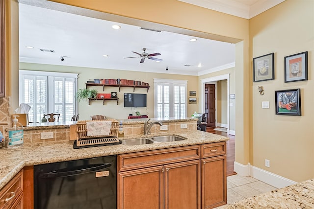 kitchen featuring crown molding, a sink, black dishwasher, and a healthy amount of sunlight