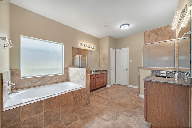 11014 Via Capri Ct, Richmond, TX 77406 - full bathroom with two vanities, a bath, and a tile shower