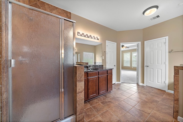 11014 Via Capri Ct, Richmond, TX 77406 - bathroom featuring vanity, a stall shower, a ceiling fan, baseboards, and tile patterned floors