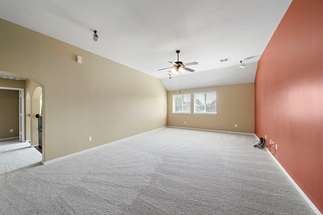 11014 Via Capri Ct, Richmond, TX 77406 - carpeted empty room featuring ceiling fan, arched walkways, vaulted ceiling, and baseboards