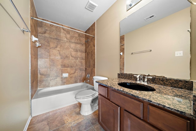 full bath with visible vents, washtub / shower combination, toilet, and vanity